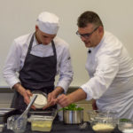 University of Rome student Lorenzo Stefanelli (left) and his professor, Chef Felice Santodonato, demonstrate a recipe for risotto.