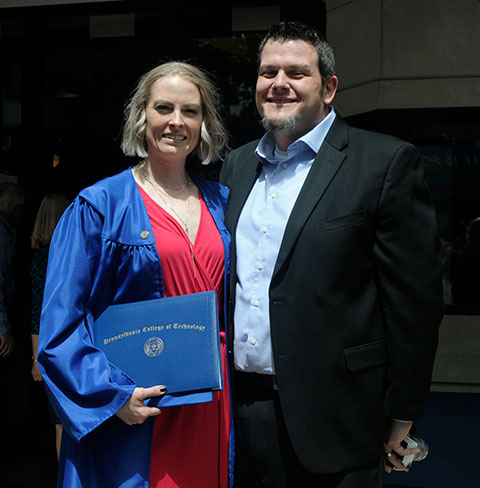 Financial Operations' William P. Kiessling proudly rejoins wife Christina M. outside the Arts Center after Saturday morning's commencement, at which she earned an associate degree in dental hygiene.