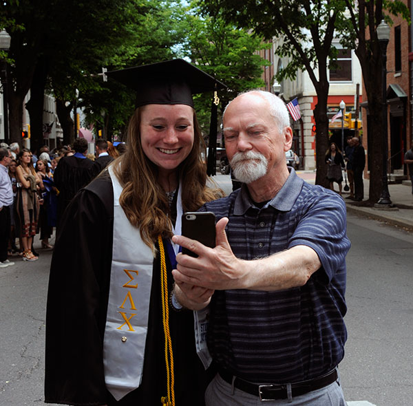Tom Zimmerman, psychology professor and faculty adviser to Wildcat Athletics, grabs a Saturday selfie with Herr.