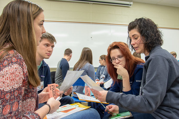 A simulated family meets and plans between “weeks.” From left are students Kaitlin L. Andersen, of Mastic, N.Y.; Matthew W. Stillman, of Kennett Square; and Sarah E. Boehnlein, of Lewisburg; and Brittany Fischer, United Way’s vice president for community action.