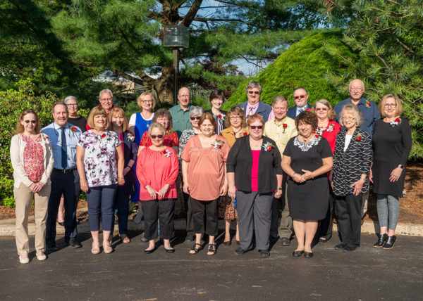 Some of this year's retirees gather with the president outside Le Jeune Chef Restaurant.