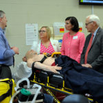 The college's newest (and most lifelike) medical manikin is introduced by Christopher T. Boyer (left), director of paramedic technology programs, and Sandra L. Richmond (right), dean of nursing and health sciences. Getting a closer look are (from right) Sens. Yaw, Phillips-Hill and Ward – a registered nurse.