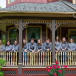 Shoulder-to-shoulder and ready to serve, Links congregate on the porch of The Victorian House. From left are Ferguson, Conklin, Santaella, Mills, Wiest, Highland, Murren, Eaton, Becker, Harriman, Decker and Morrin. 