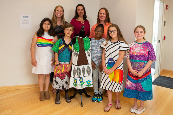 Expanding on the creative collaboration, Cochran Primary School students model dresses inspired by their dress prints. The dresses were made by Elizabeth Wislar (center rear), Lycoming College costume designer and costume shop manager. Enjoying the “premiere” with their students are Elizabeth A. Sauers (left rear), third grade teacher, and Chelsea Cramer (right rear), art teacher. 