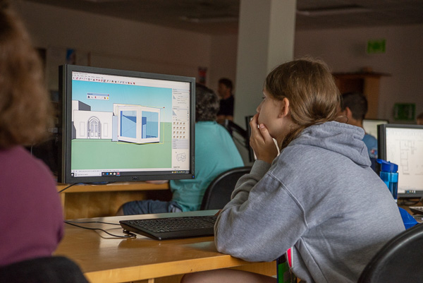A young girl explores the amazing software options available in the architecture field.