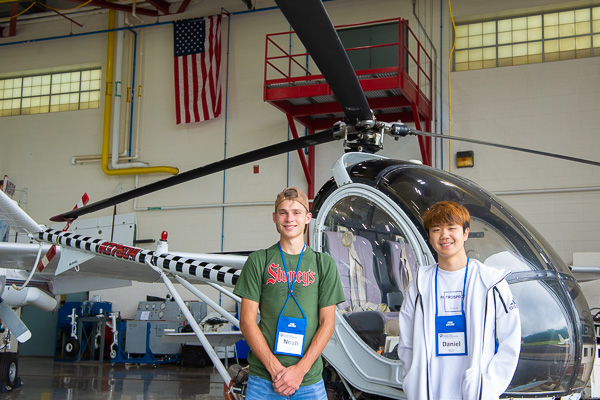 Obliging a photographer’s request, two Aviation campers pause in the hangar.