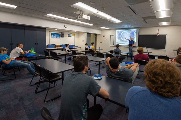 Aviation campers gain engine insights from Michael R. Robison, aviation instructor. 