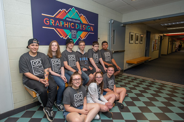 Campers gather in the graphic design hallway prior to their closing exhibition …