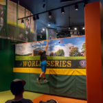 Reaching for the sky, a boy goes airborne to loft a ball over the 8-foot "fence."