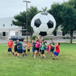 Not far from Penn College's new turf field, youngsters cavort with a larger-than-life accessory.