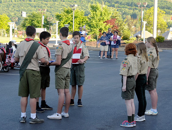 Members of Troop 38B and 38G, from the Church of St. Ann, fold the flag as master of ceremonies William P. Carlucci explained each symbolic step in the process.