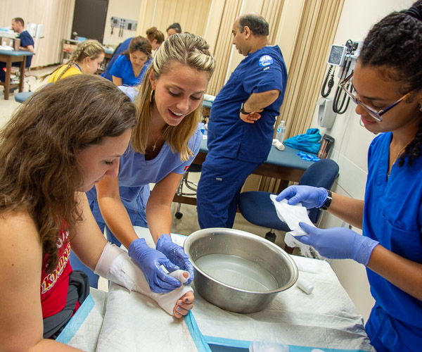 In the physician assistant lab, participants receive hands-on lessons – and casts – from students.