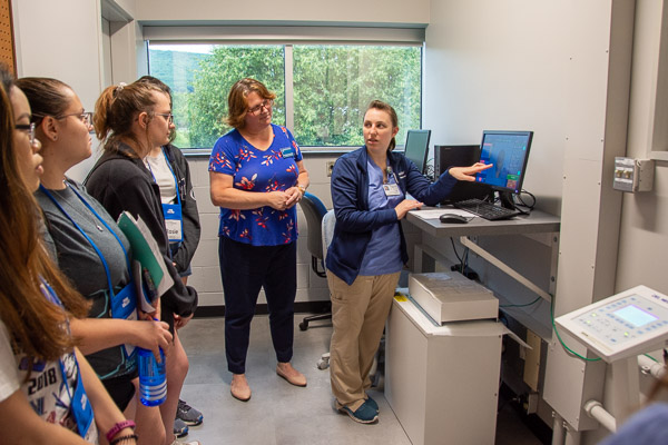 Radiography student Adrianne A. Nicholas, of Turbotville, shows Health Careers participants a digitally captured X-ray image. Joining them is Karen L. Plankenhorn, clinical supervisor of radiography.