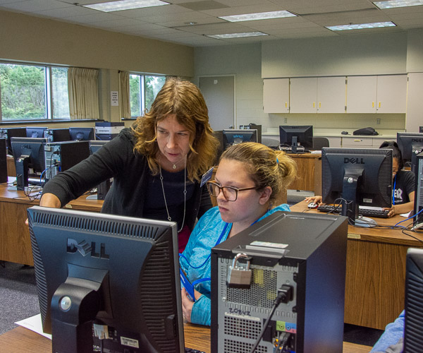 Michelle M. Budnovitch, instructor of business administration/health information technology, provides assistance in updating a patient record.