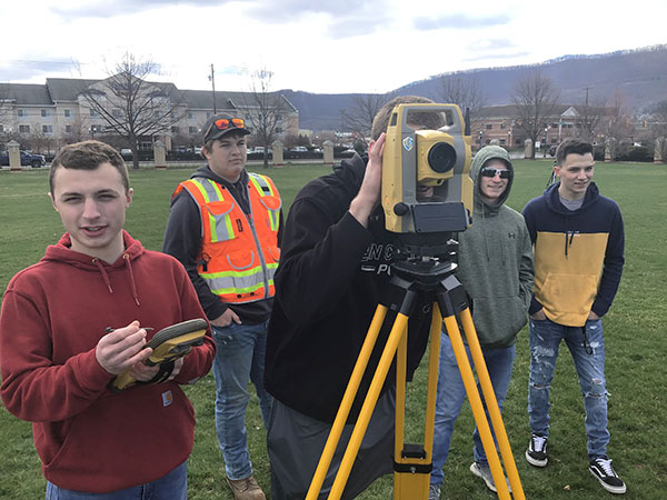Junior civil engineering technology students test their recall from freshman year about operating a total station. 