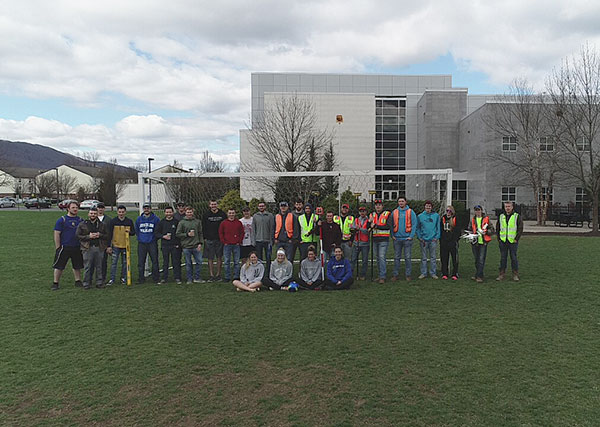 Penn College civil engineering technology and surveying technology students and women’s soccer team members pose at the completion of the collaborative learning activity.