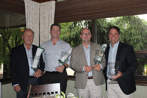 Brent Fish (right), of Fish Real Estate (among the day's player sponsors), celebrates with his winning foursome.