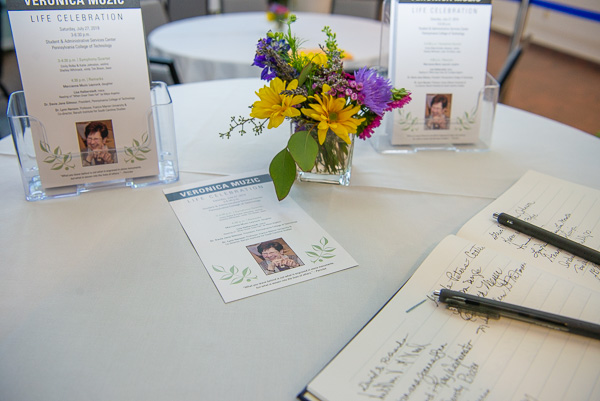 A guestbook and program punctuate the day's celebratory intent.