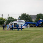 Students gather around one of Geisinger’s Life Flight helicopters after it touches down on the library lawn.