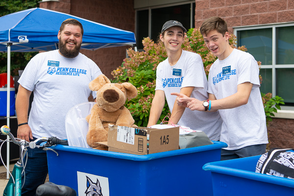 A stuffed animal is among the “creature comforts” handled with care by Resident Assistants (from left) Joseph “Joey” C. Suto, Tucker L. Burner and Elias D. Ritter. 