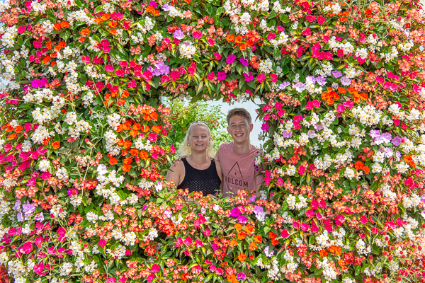 Making a memory with Mom. After moving into his room, Taylor J. Elliott and his mother enjoy a photo op at the floral frame near College Avenue Labs. Elliott, from State College, is enrolled in welding technology. 