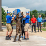 Student-athletes lift the covering, stitched together in Penn College's signature blue and gray, to bring the "Bases Loaded" outfielder to daylight.