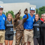 The president joins the student-athletes alongside the statue they unveiled. From left are Nathan D. Holt, of Shippensburg; Olivia R. Hemstock, of Northford, Conn.; Max A. Conrad, of Hagerstown, Md.; and Gillian D. Sinnott, of Sykesville, Md.