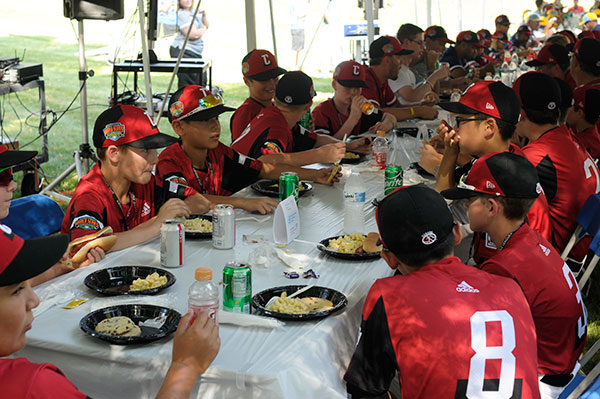 The Canada squad, representing Vancouver, British Columbia, sits down to a picnic feast.