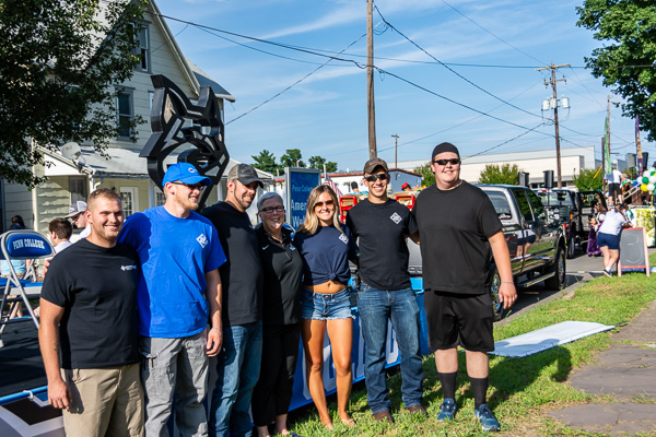 President Gilmour joins members of the American Welding Society student chapter, who fashioned the metal Wildcat head on the float.
