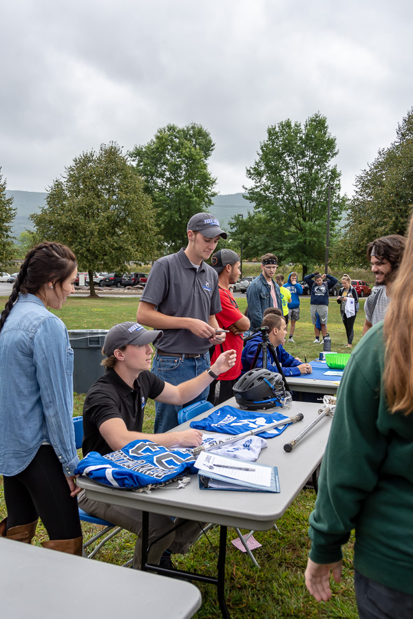 Equipment and a signup sheet draw onlookers to men's lacrosse, a club sport that competes in the National College Lacrosse League.