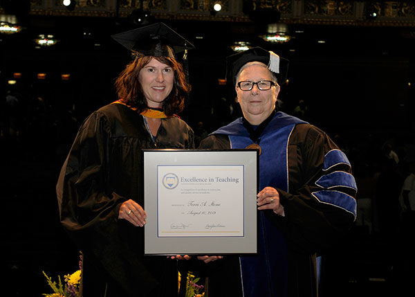 Terri A. Stone (left), assistant professor of nursing programs, was presented with an Excellence in Teaching Award by President Davie Jane Gilmour during Pennsylvania College of Technology’s Summer 2019 Commencement ceremony Aug. 10 at the Community Arts Center.