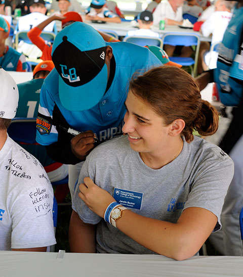A Caribbean player (from Willemstad, Curacao) signs the T-shirt of Janelle R. Becker, of Fort Loudon.
