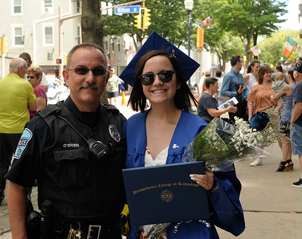 Proud Penn College Police Officer Charles E. O’Brien Jr. reconnects outside with his daughter, Aidan E., after she received an associate degree in health arts: practical nursing emphasis