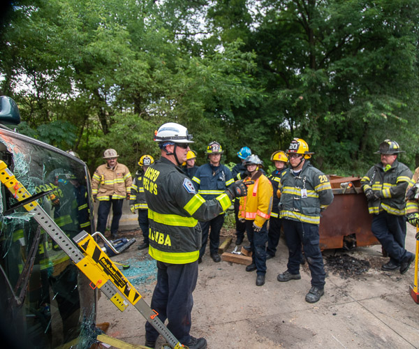 Firefighter/Paramedic Mark Taluba, of Anne Arundel County (Md.) Fire Department, leads students through a vehicle rescue at the CAFCA training site. Taluba is a 1999 graduate of Penn College’s environmental technology major.