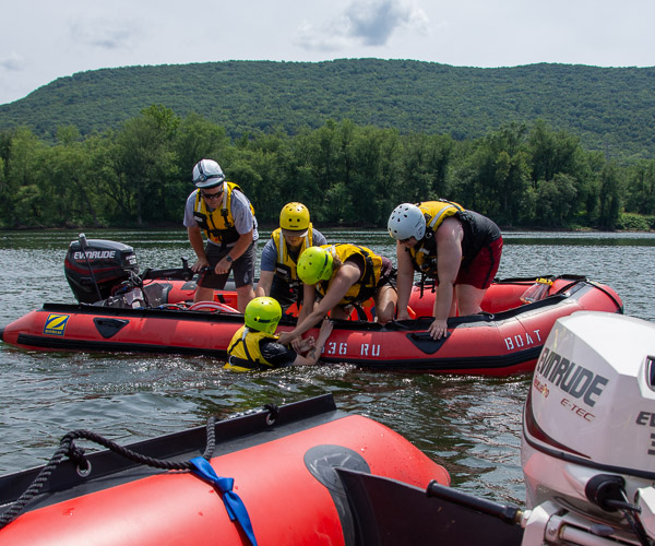 Aboard a Williamsport Bureau of Fire rescue boat, piloted by the bureau’s Kenny Smith, fire engineer, students pull classmate Marissa L. Davis from the water. Davis is from Trafford.