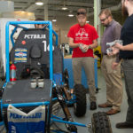 In the manufacturing lab, Cutler learns about the mechanics of BAJA team racing from students including John D. Kleinfelter (center in red shirt), a manufacturing engineering student from Lebanon. 