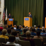 SGA President Patrick C. Ferguson (left) welcomes the audience and introduces the candidates: Slaughter (center) and Beiter.