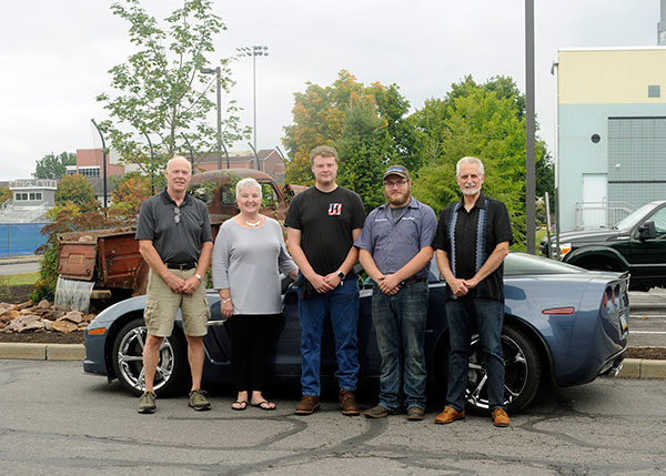 Gathered near the restoration-themed water feature at Pennsylvania College of Technology are (from left) Susquehanna Valley Corvette Club members Keith and Jan Hoffman, who brought their 2011 Corvette Grand Sport 3LT to campus; scholarship recipients Chase T. Fritz, of Athens, and Jacob A. Dock, of Middleburg; and Al Clapps, chairman of the SVCC Car Show Committee.