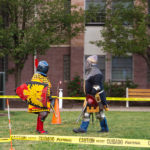 Throwing caution to the early-autumn breeze, armored contestants prepare to do battle in the Rose Street Courtyard.