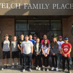 Golf, softball and men’s soccer student-athletes line up outside the library's Welch family wing.