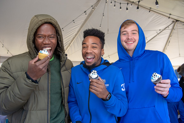 Sugar rush! Enjoying the day’s delights are student-athletes (from left): Momolu Dorley, Trey McCullough and Will F. Sulesky. All are on the men’s basketball team. 