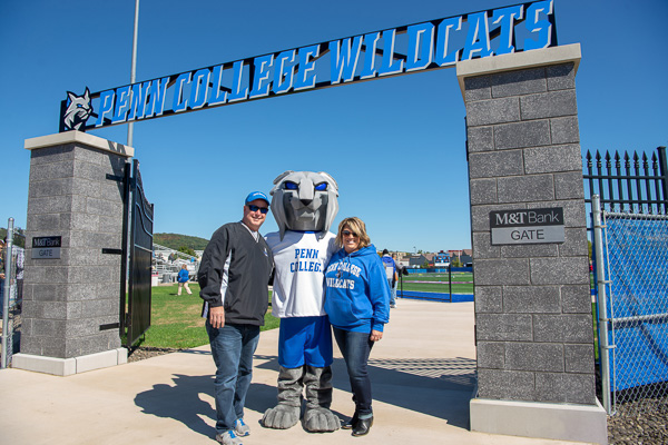 Brian and Michelle Layne, parents of men’s soccer team member, Tanner J. Layne, of Chesapeake, Virginia, “paws” for a photo with “The Big Cat on Campus.” 