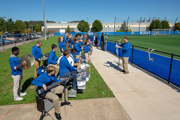 The pep band, conducted by aviation maintenance instructor Michael Damiani, plays the national anthem.