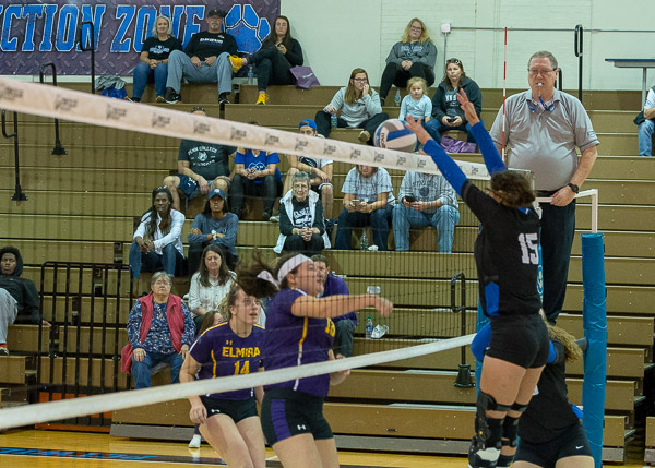 Emalie M. Marnati (15), with one of her two blocks against Elmira College on Saturday.