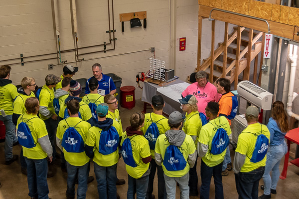 Engaging visitors in the HVAC lab are faculty members Stephen D. Manbeck (in blue shirt) and Marc E. Bridgens (in pink).