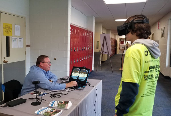 Carl J. Bower Jr., assistant professor of horticulture, coaches a visitor through virtual reality landscape design.