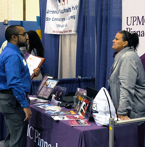 Mohanad T. Alquraish, a nursing student from Saudi Arabia, talks with Kimberly Kinard about health care opportunities with UPMC Pinnacle.