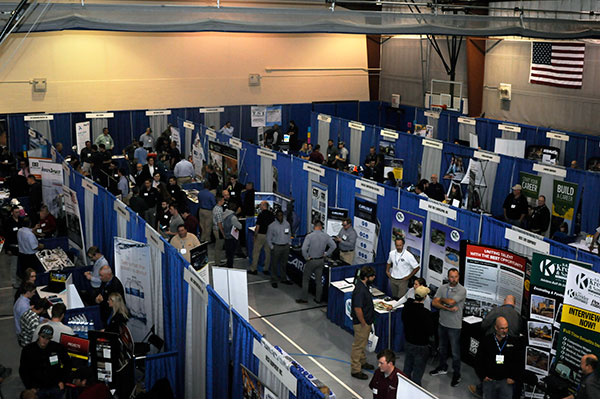 Current students and job-hunting alumni work a Field House floor full of vendors.