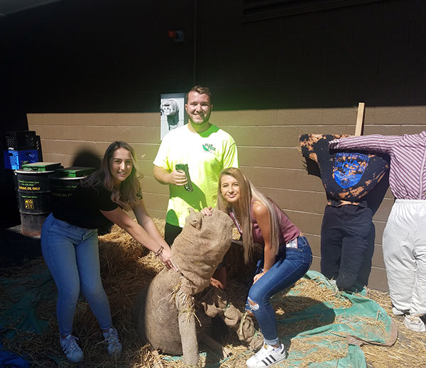 Stuffing hay while the sun shines are (from left) landscape/horticulture technology students Taylor L. Keiper, of Archbald; Robert J. Williamson, of Fort Washington; and Valarity C. Oxford, of Muncy. Oxford is enrolled in the major's plant production emphasis; Keiper and Williamson are in the landscape emphasis.