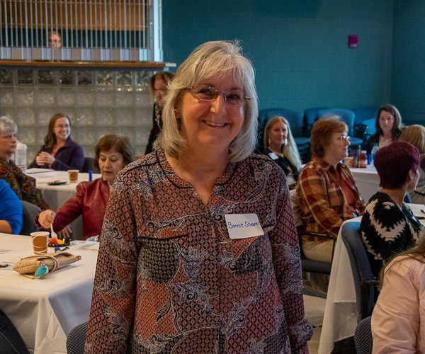 A member of the first dental hygiene class in 1979, Bonnie Shearer, stands up to be recognized by Shawn A. Kiser, director of dental hygiene. Shearer’s classmate Suzanne Pearson was also among the 85 alumni and faculty members in attendance for the program’s reunion, which included a continuing education seminar, lunch, and tours of the dental hygiene clinic.